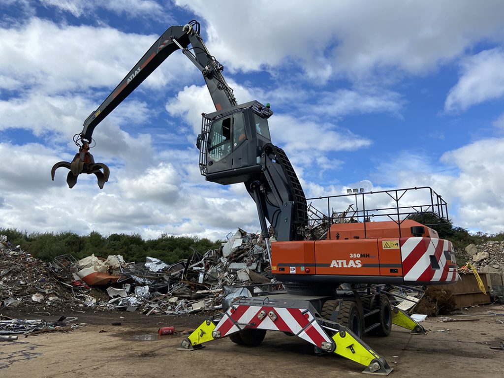 Atlas 350MH material handler with grab in scrap metal yard