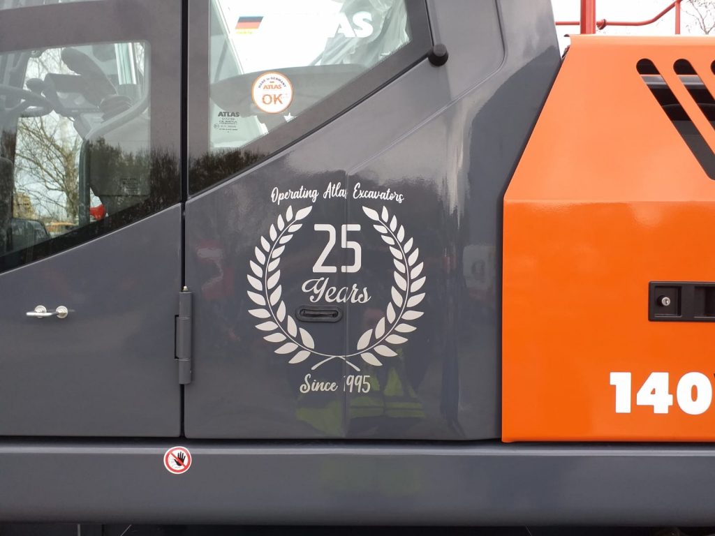 Celebrating 25 years crest on Atlas 140W wheeled excavator