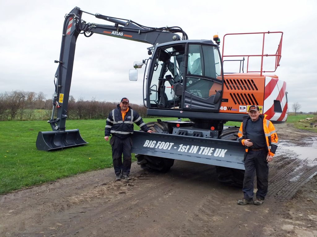 Richard and Dave Bichan with new Atlas 140W Bigfoot Wheeled Excavator