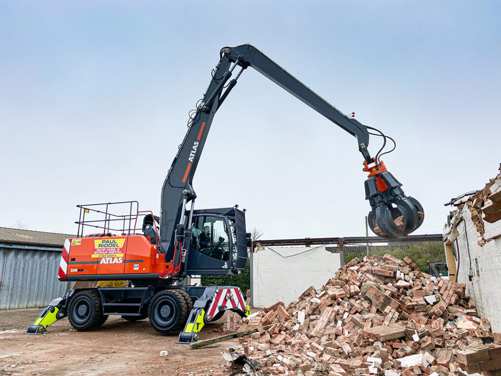 atlas material handler with grab moving bricks